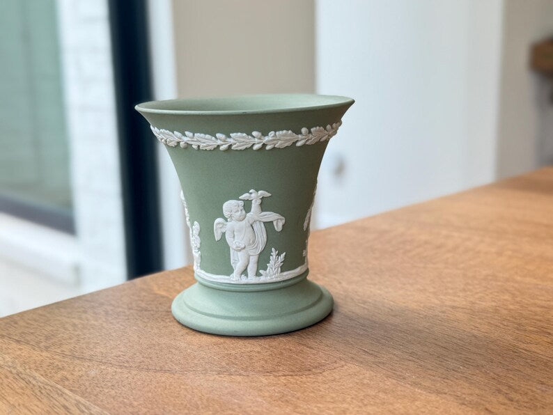 Vintage Wedgwood sage green Jasperware flared trumpet vase — featuring neoclassical putti bas-relief figures.