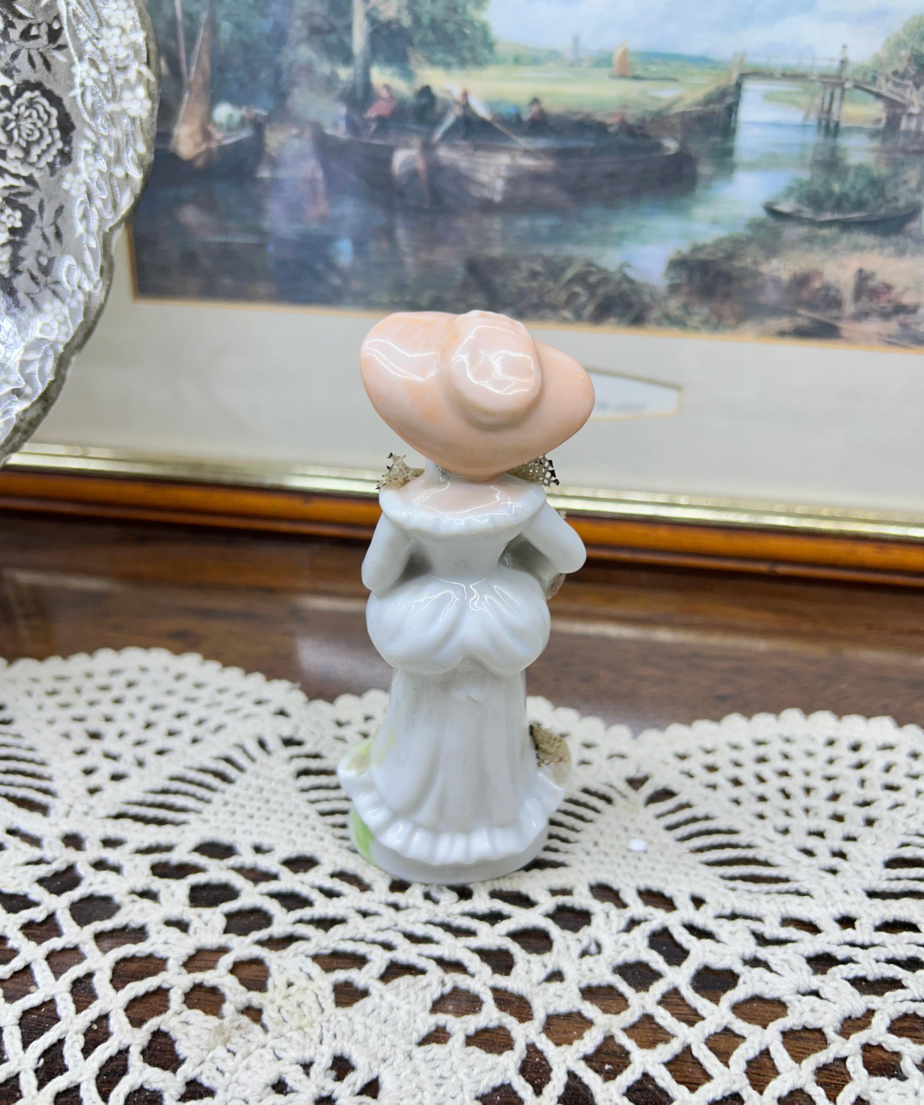 vintage Lefton figurine depicts a Victorian lady in a yellow-striped dress