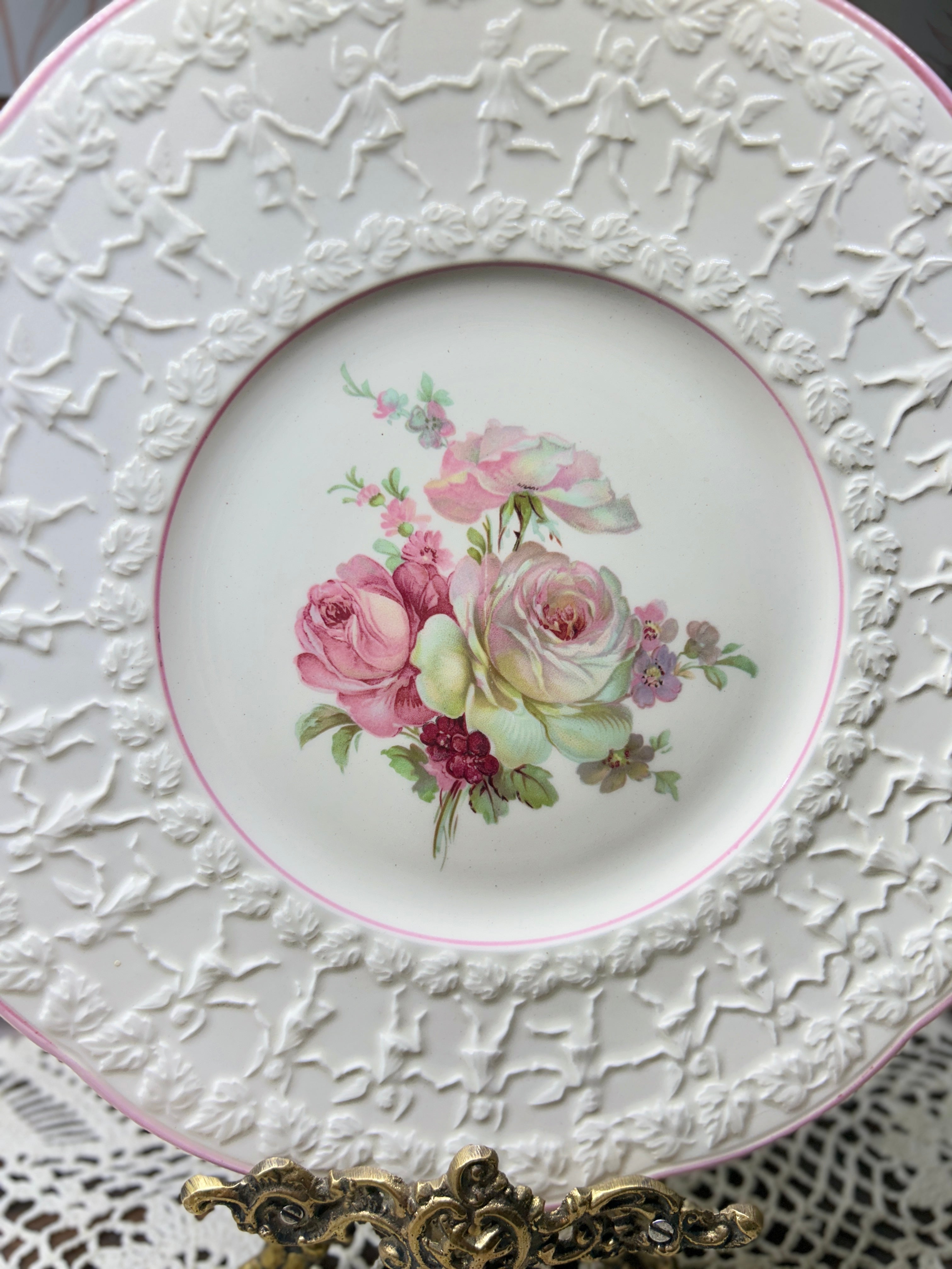 Vintage Crown Ducal Rose Marie pattern wall plate featuring a pink-tinted rim and a central rose bouquet 12”