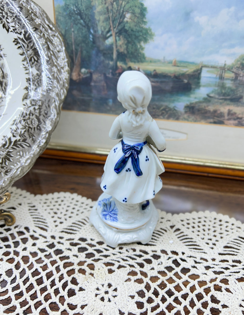 Vintage hand-painted figurine with blue accents featuring a girl with goose 6”