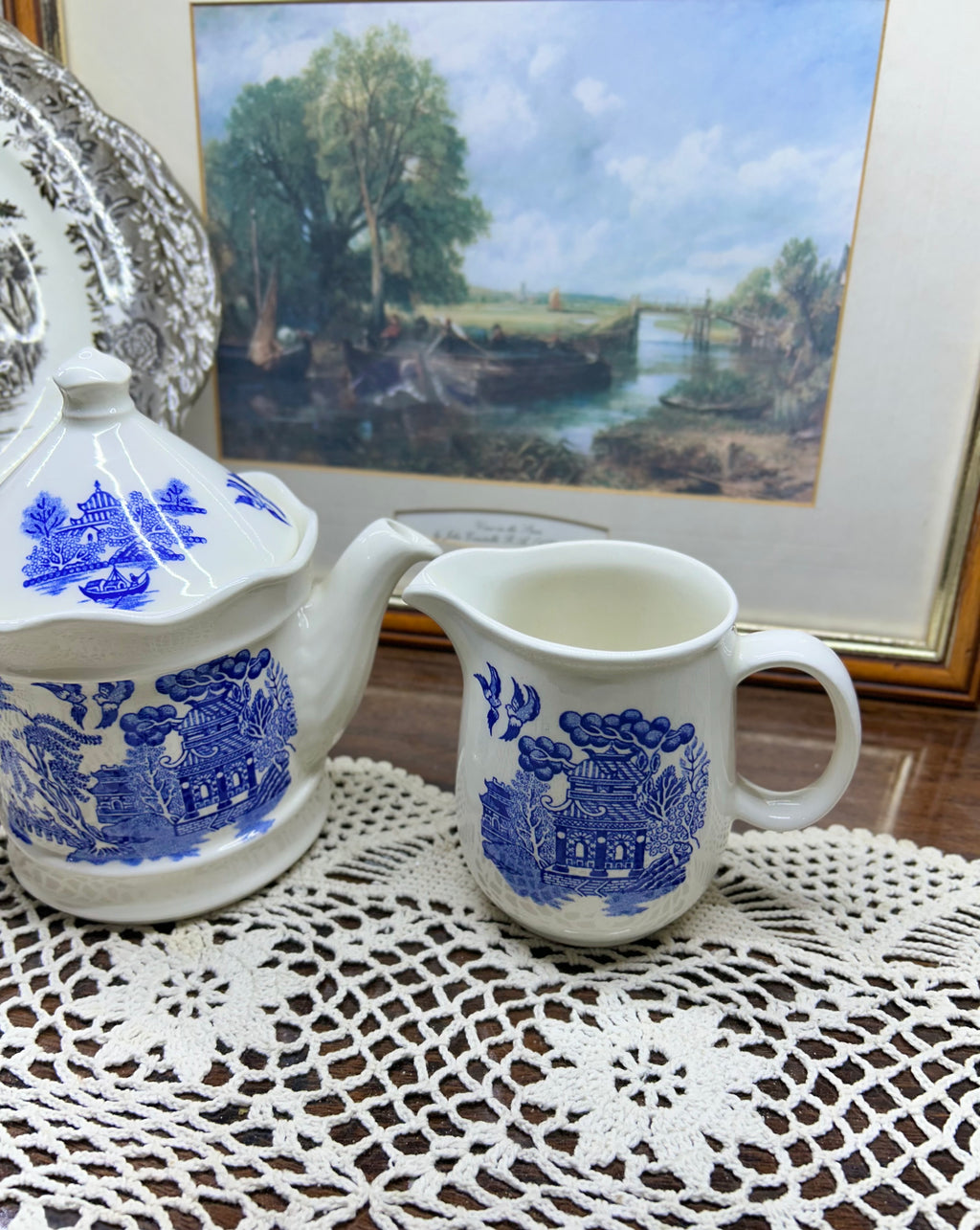 Vintage Shenango China teapot and matching creamer set featuring the iconic Blue Willow pattern.