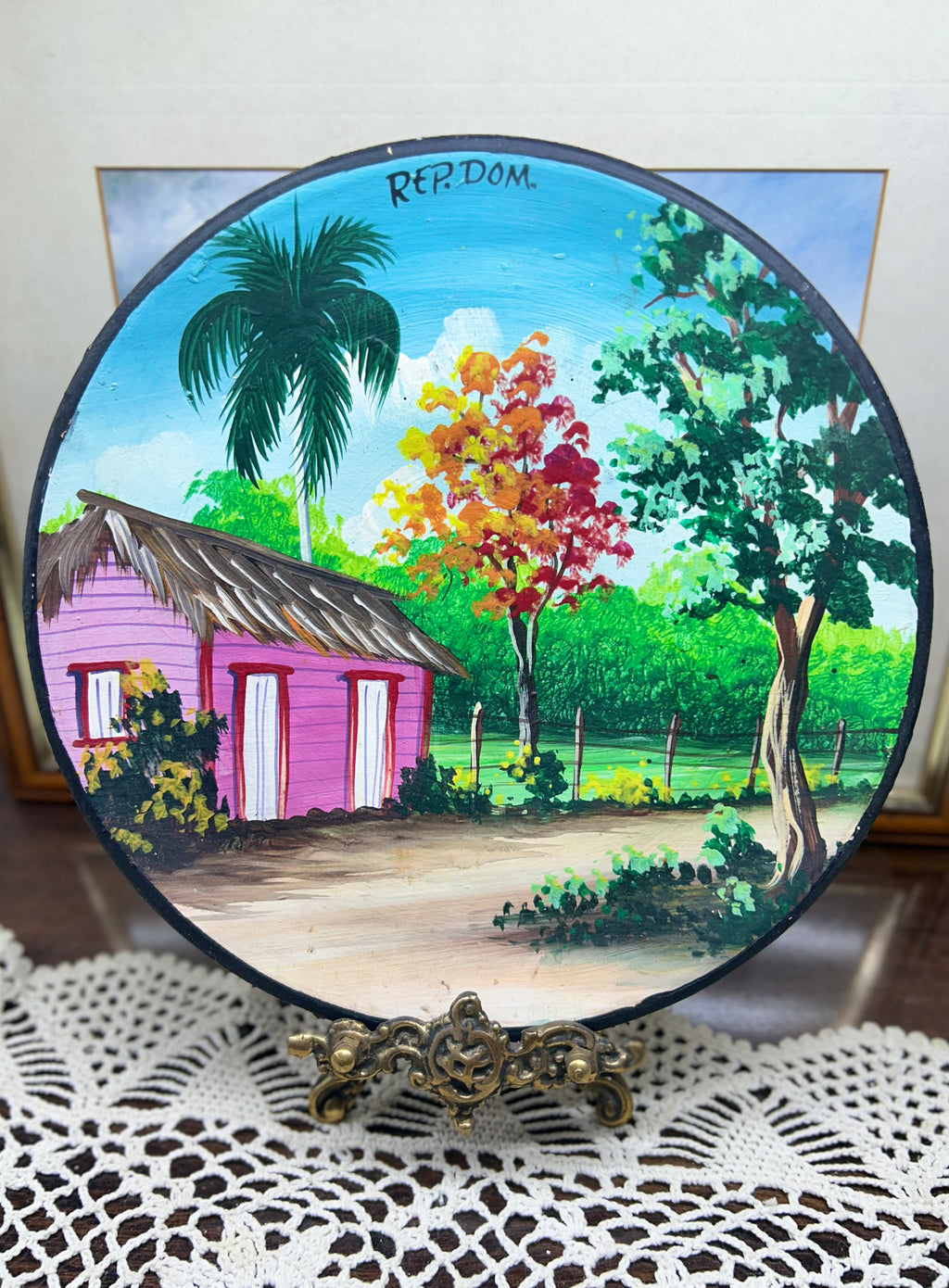 Hand-painted decorative plate featuring a vibrant Caribbean landscape from the Dominican Republic